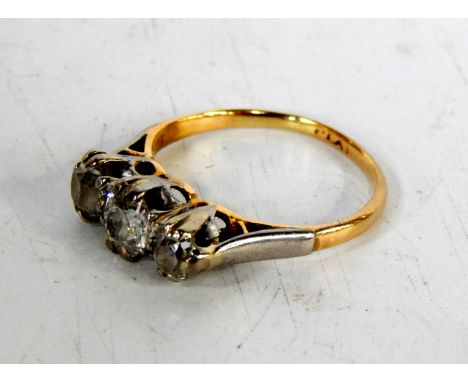 A three stone diamond half hoop ring, with platinium claw setting and yellow metal band.