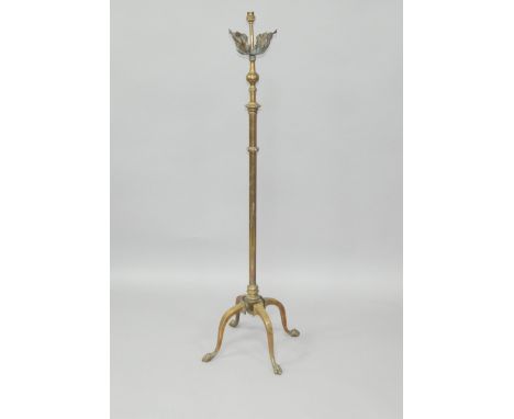 A Victorian brass telescopic oil lamp stand, converted to electricity, raised on four cabriole legs and paw feet, 136cm high.