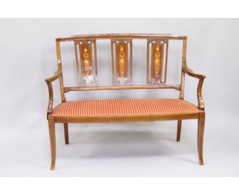 An Edwardian mahogany and satinwood inlaid open back two seater sofa, with striped fabric seat, raised on out swept legs, 103