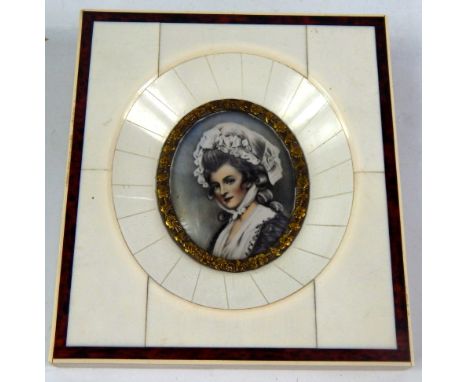 A portrait miniature of a lady, 20thC, wearing a mob cap, piano key ivory framed, 10.5cm x 9.5cm.