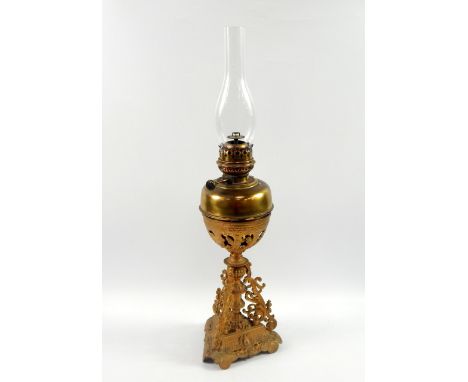 A Lampe Veritas brass oil lamp, in a gold painted triform cast iron stand, 69.5cm high.