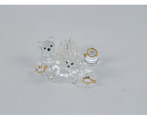 A Swarovski crystal swan, cat, teddy bear, rabbit, kettle and two tea cups on saucers, (7).