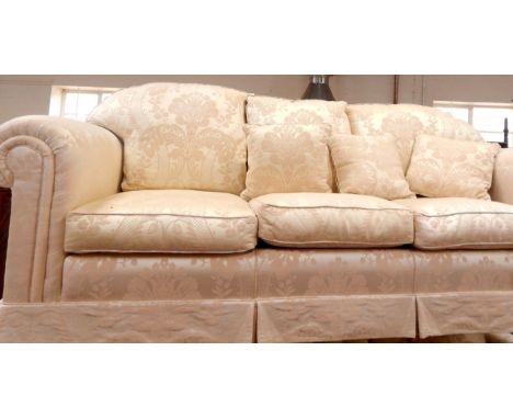 A Rousseau three seater sofa, upholstered in patterned ivory damask, 220cm x 92cm x 92cm.