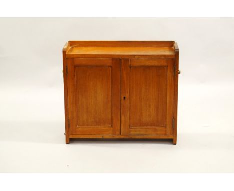 A mahogany wall cabinet, early 20thC, two doors enclosing a single shelf, 61cm x 17.5cm x 53.5cm.