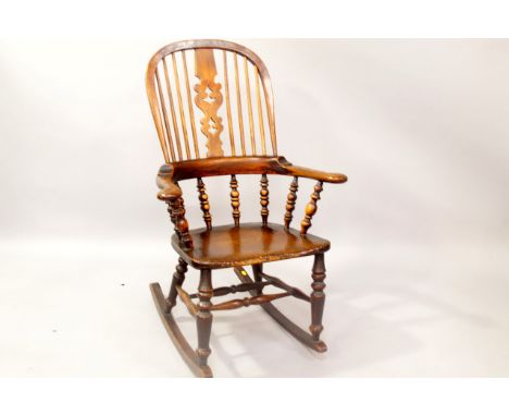A 19thC ash and elm rocking grandfather chair, with Christmas tree splat and bobbin turned supports.