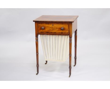 A George IV mahogany and rosewood crossbanded sewing table, single drawer above a pleated fabric covered basket, raised on ri