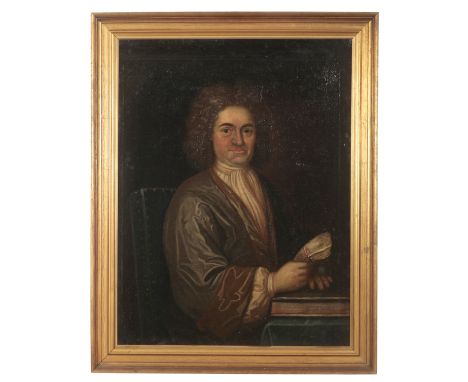 ENGLISH SCHOOL, 18TH CENTURY A portrait of a gentlemandepicted half-length wearing a curled wig and clutching a document, oil