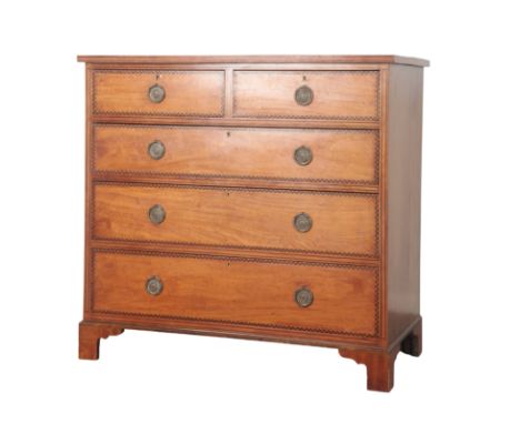 AN EDWARDIAN SATINWOOD AND PARQUETRY STRUNG CHEST OF DRAWERS with two short and three long drawers on shaped bracket feet, 10