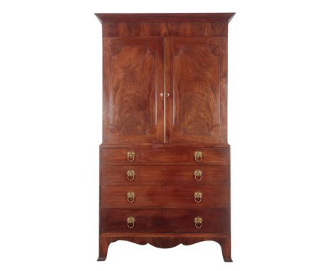 A GEORGE III FIGURED MAHOGANY LINEN PRESS with tall flared cornice, the upper part fitted with two sliding trays enclosed by 