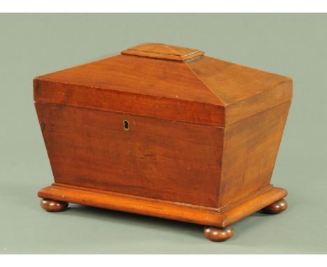 A William IV mahogany tea caddy, of sarcophagus form, raised on short bun feet.  Width 31 cm. 