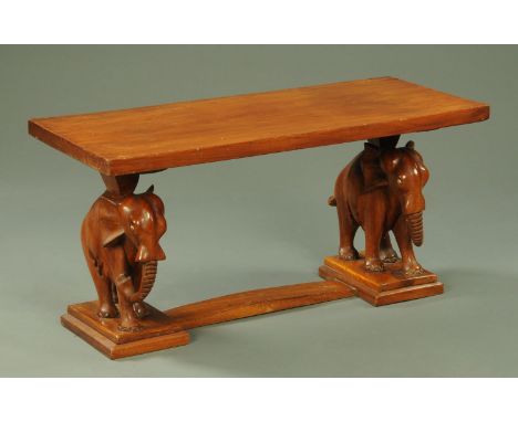 A vintage coffee table, with carved elephant supports and low stretcher.  Top 101 cm x 45.5 cm.