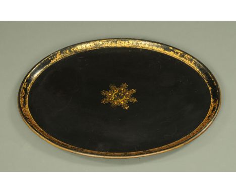 An early 19th century papier mache oval tray, with gilt medallion to centre and gilded borders, the underside marked with a s