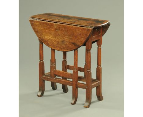 An antique oak small gate legged occasional table, with turned supports and single end drawer, with outswept feet.  Width 68 