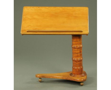 A Victorian satin birch adjustable reading table, the rectangular top with moulded edge raised on a ring turned column with t