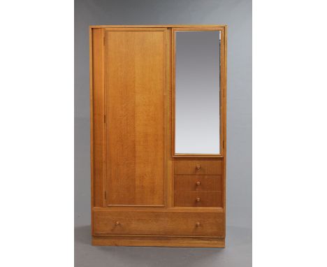 A Heal's of London light oak combination wardrobe, mid 20th century, fitted with hanging space and drawers.  Width 107 cm, he