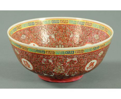 A Chinese blessings bowl, 20th century, decorated throughout with a tight scroll pattern with peony leaves and bats, the cent