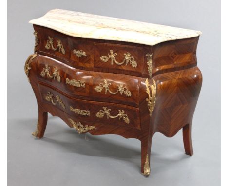 A marble topped four drawer commode chest, with cream and grey variegated marble top, kingwood veneered body with two short a