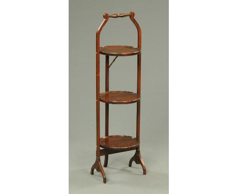 An Edwardian mahogany three tier folding cake stand. CONDITION REPORT: Generally in good order throughout.  However there is 