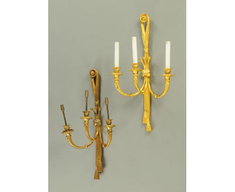 A pair of gilt metal three branch wall light fittings.  Height 69 cm, width 37 cm. 