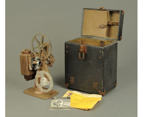 A revere 8 mm cine projector, in case and with original receipt dated 1942.