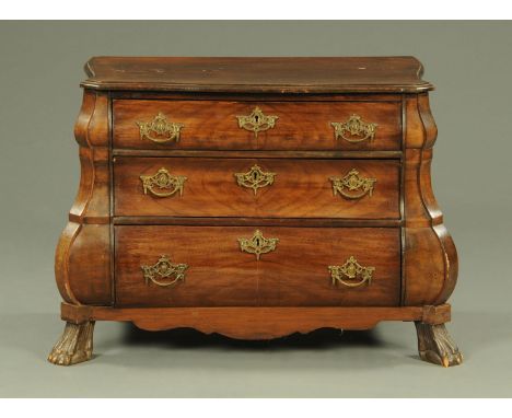 A Continental serpentine fronted miniature commode, with three oak lined drawers and cast metal handles and escutcheons, supp