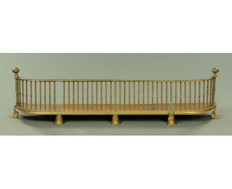 A Victorian brass fender, with spindled gallery and raised on short feet.  Width 132.5 cm.