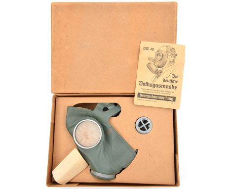 A WWII period German civilian gasmask (Volksgasmaske), in its original carton with printed instruction leaflet. In unissued c