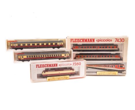 9 N gauge locomotives and coaches by Fleischmann, Minitrix and Lima. A DB 3 car diesel multiple unit in orange and grey liver