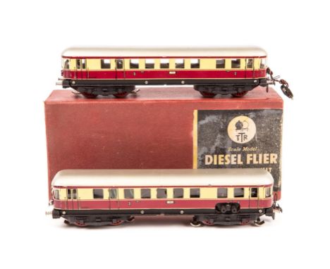 A Trix OO Scale Model Diesel Flier 20/58. A two-coach unit with lights in maroon and cream German DB style livery. Boxed, min