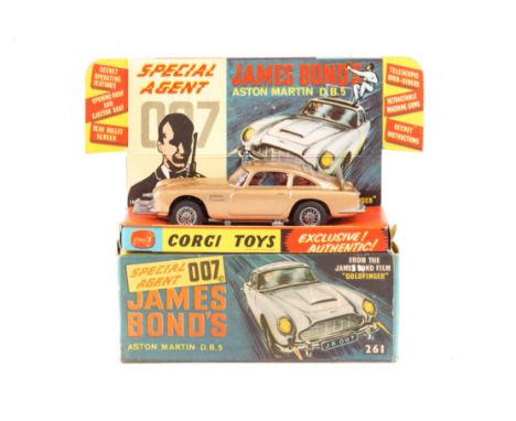 A Corgi Toys James Bond Aston Martin DB5 (261). An early example in metallic gold with red interior. James Bond and bandit fi