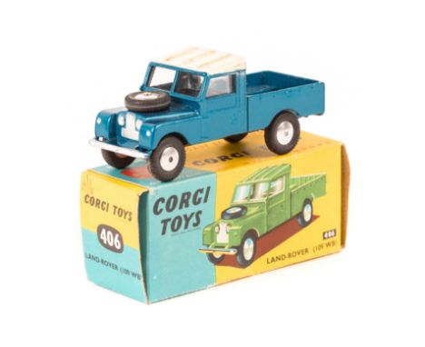 A Corgi Land Rover 109" WB (406). An example in metallic blue with cream roof and flat spun wheels. Boxed, minor wear/creasin