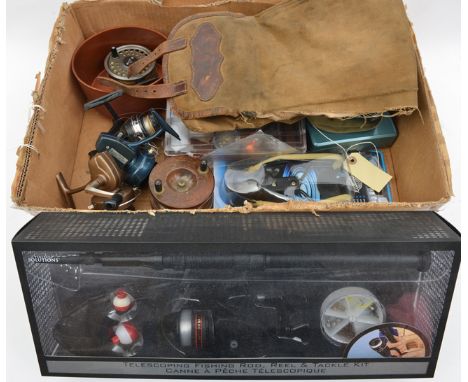 A box of fishing items, including an old brass mounted mahogany reel, 4 other reels, a modern “fishing catapault” and “Telesc