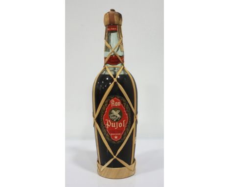 RON PUJOL C. 1950We estimate this bottle of rum as being from the 40's or early 1950's.  Ron Pujol Sociead Anonima Pujol Y Gr