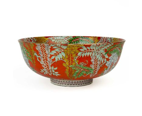 A Japanese porcelain bowl, early 20th century. The red ground with painted enamel decoration of wisteria, four character seal