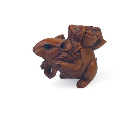 A Japanese miniature carved wood netsuke of a mouse, signed. Carrying a basket, height 1.8cm, width 2.5cm, depth 1cm.