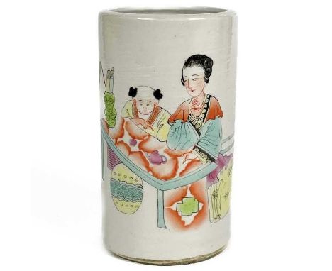 A Chinese famille rose porcelain brush pot, 20th century. Four-character red mark, with figures at a table in a garden, verse