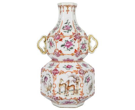 A Chinese famille rose porcelain double gourd vase, circa 1760. With twin handles and decorated with bats, deer and fish, old