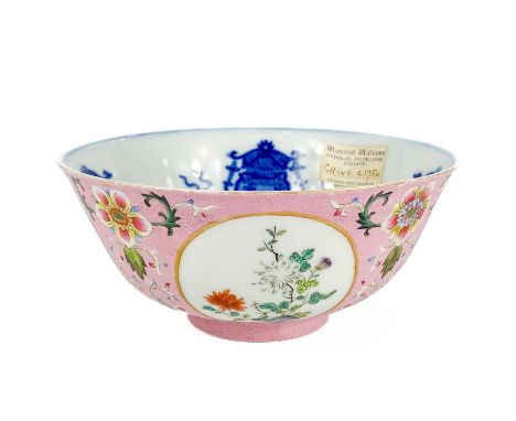 A Chinese famille rose porcelain bowl, 20th century. With spurious paper label, the pink enamelled floral decorated ground wi