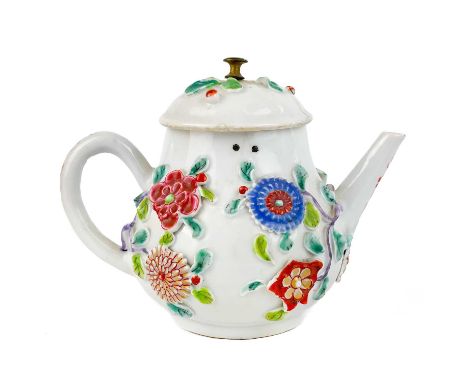 A Chinese porcelain teapot, mid 18th century. .With applied floral and leaf decoration, height 12cm, length 16cm, depth 9.5cm