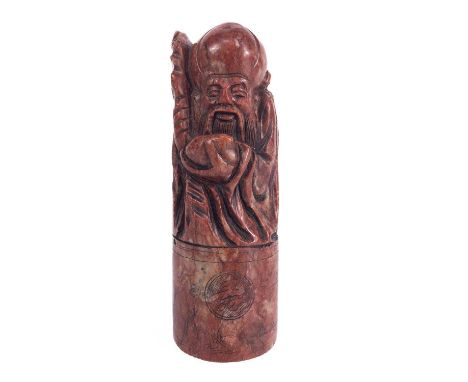 A Chinese carved hardstone seal, circa 1900. Depicting Shoulao the God of Longevity, with a staff and holding a peach, height