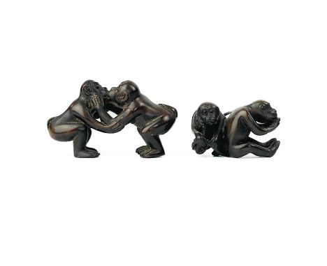 A Japanese carved wood netsuke of two monkeys. Height 2.5cm, width 4cm, depth 2cm and a similar carving, height 4cm, width 6.