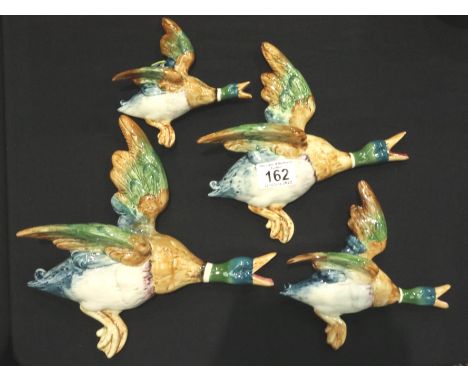 Set of four Beswick flying ducks (5961, 5962, 5963, 5964), some damages. Wing re glued on number three duck, heavy crazing on