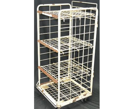 A vintage four tier wheeled storage rack
