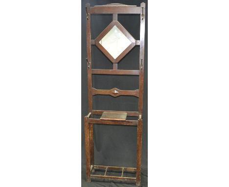 An oak hall stand, diamond shaped mirror and hooks to top, stick stand to base, circa 1940. 193cm high x 60cm wide x 23cm dee