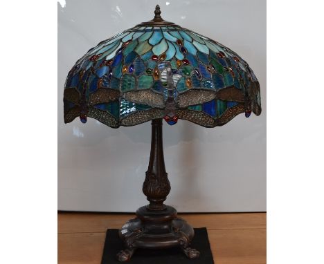 A large Tiffany style table lamp, the colourful glass shade applied with dragonflies, cast metal support, approx 71cm high, 5
