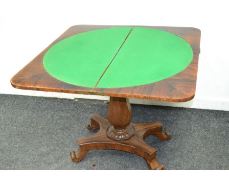 A Victorian rosewood card table, the top opening to circular baize playing surface 