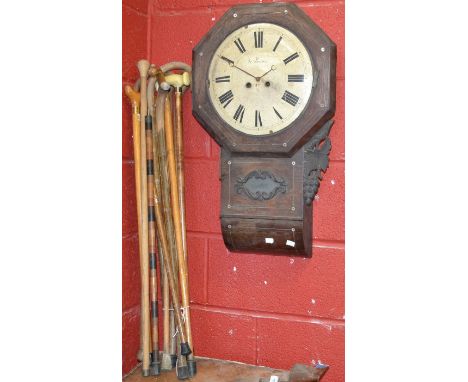 Walking sticks - a mixed wood banded shaft walking stick; others; a carved case drop dial wall clock