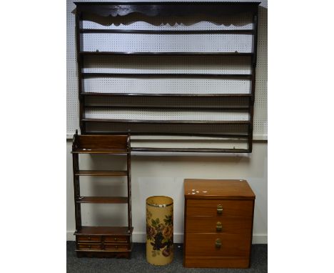 An oak wall mounted plate rack;a teak wall shelf, pierced uprights, four shelves over four short drawers; a retro teak three 