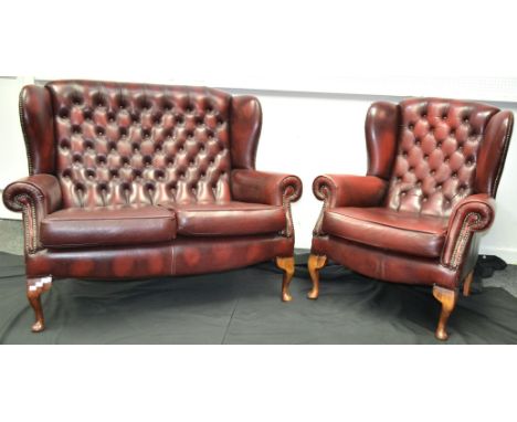 A two seat high back Chesterfield sofa and conforming armchair