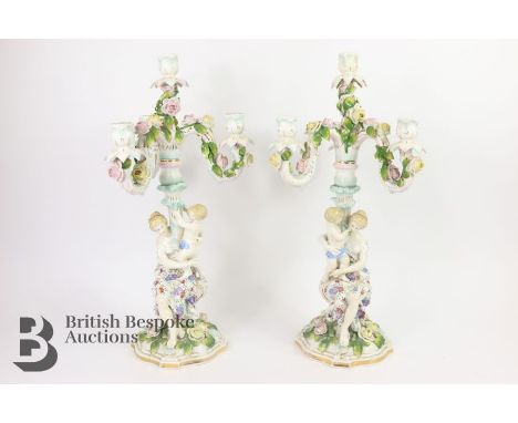 Pair of Continental figural four light candelabra, a mother and infant arranged around a central column with applied flowers,